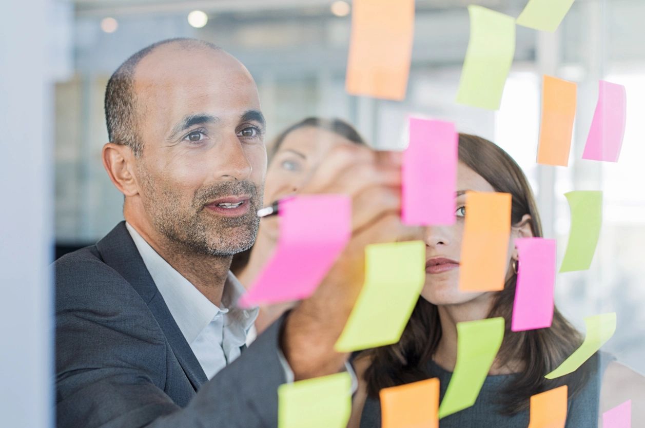 Business colleagues brainstorming with sticky notes
